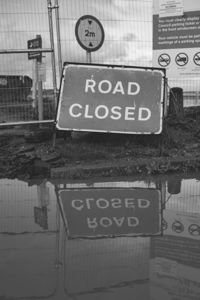 grayscale photo of road closed